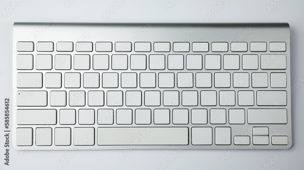 Fototapete gray keyboard with white buttons. wireless keyboard. computer components. text input device. keyboar