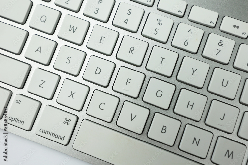 Fototapete gray keyboard with white buttons. wireless keyboard. computer components. text input device. keyboar
