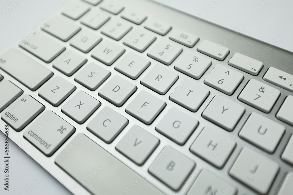 Fototapete gray keyboard with white buttons. wireless keyboard. computer components. text input device. keyboar