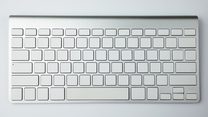 Gray keyboard with white buttons. Wireless keyboard. Computer components. Text input device....