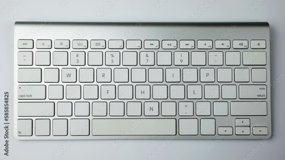 Fototapete gray keyboard with white buttons. wireless keyboard. letters and symbols begin to appear on empty bu