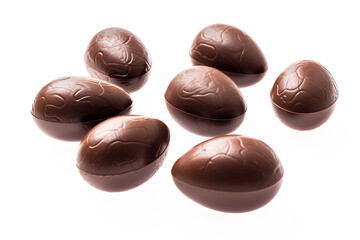 a group of chocolate eggs on a white background