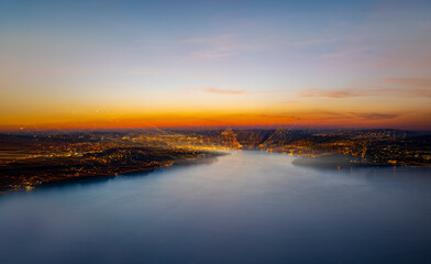 Aerial View over Mountain and Lake and City Lucerne in a Dusk with Light Trails in Lucerne, Switzerland.