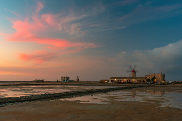 Obraz premium View on the windmill at dusk, Salt pans of Trapani IT