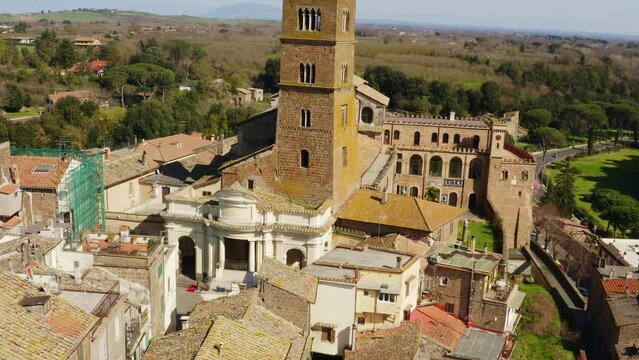 Aerial view of the cathedral Santa Maria Assunta in the historic center of Sutri, town located near Viterbo and Rome, Italy. The Romanesque church with its bell tower dominates the city.