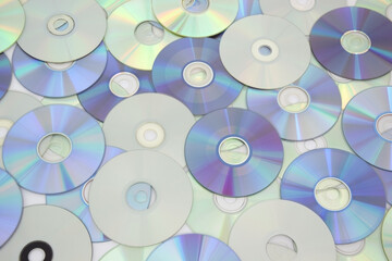 Lots of old CDs are laid out as a background.