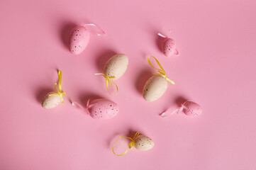 Flat lay with beige and pink pastel Easter eggs on isolated pink background with copy advertising space. Still life. Easter celebration concept. Copy ad space. Christianity. Religious holiday concept