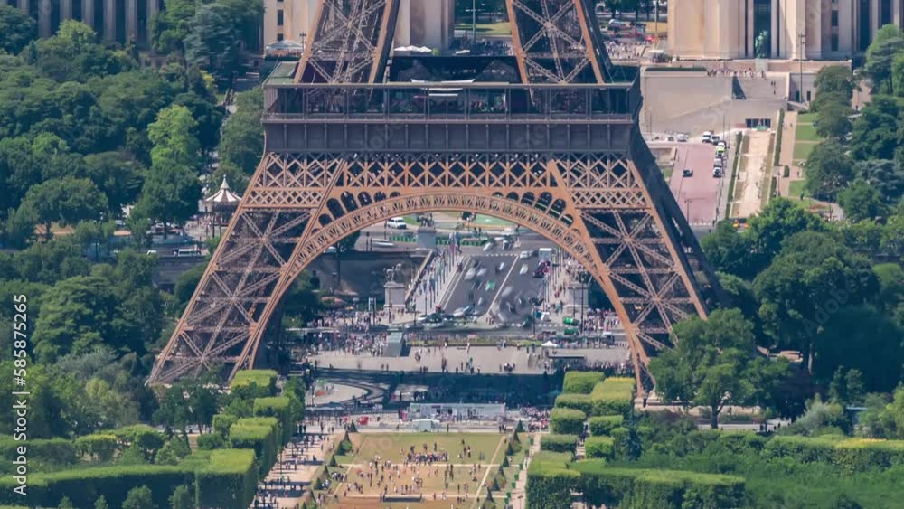 Wall mural Aerial view from Montparnasse tower with Eiffel tower bacement and Champ de Mars timelapse in Paris, France. Top view from observation deck at sunny summer day.