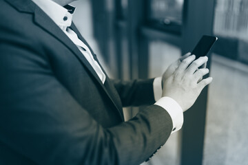 Obraz premium Close up of young business man and digital number of stock market background to represent successful in investment marketing. Find out the best solution in business and financial as concept.