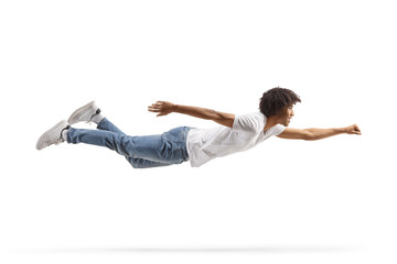 African american guy in jeans and white t-shirt flying