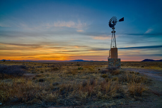 Water pump Windmill at dusk, City of Rocks State Park, NM.
