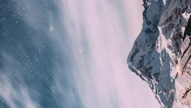 Timelapse Close Up View Of Amazing Bright Peak Of Mount Covered Snow. Winter Nature Landscape. Hyperlapse. Vertical Footage Video. From Evening To Night Transition. Bold Blue Background Sky.