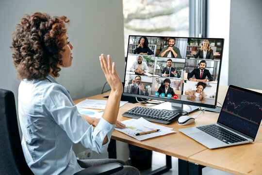 Confident successful businesswoman, company boss, stock investor, having financial brainstorm with group of multiracial people by video conference, discuss investments in the stock market, risks