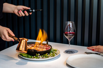  Steak flambé at table in gourmet restaurant