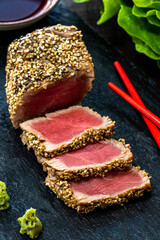 Vertical close up of appetizing sesame crusted tuna steak