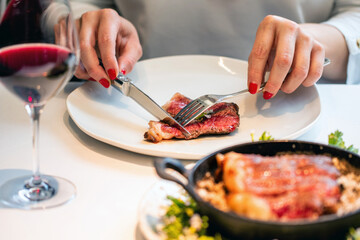 Woman enjoying sirloin angus steak in restaurant