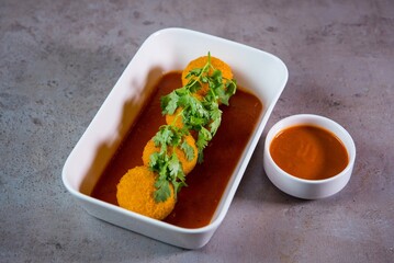 Jalapeno cheese balls with tomato sauce served in dish isolated on grey background top view of...