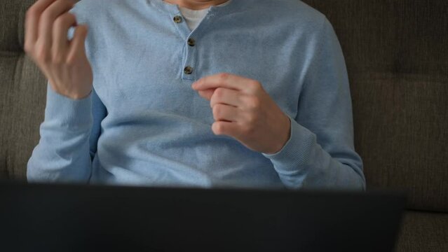 Deaf or dumb man communicating in sign language in video chat, close-up
