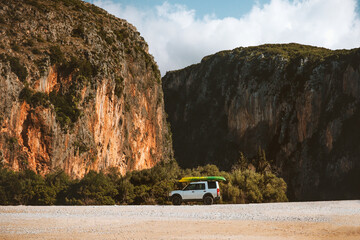 Road trip in Albania car camping with Gjipe canyon view on the beach travel on wheels summer vacations outdoor mountain landscape © EVERST
