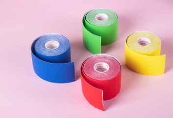 Colorful kinesiology tape on pink background, kinesiology taping lymph outflow and speeds up the healing process