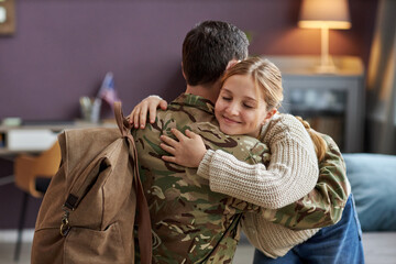 Portrait of smiling girl hugging father coming back home from military