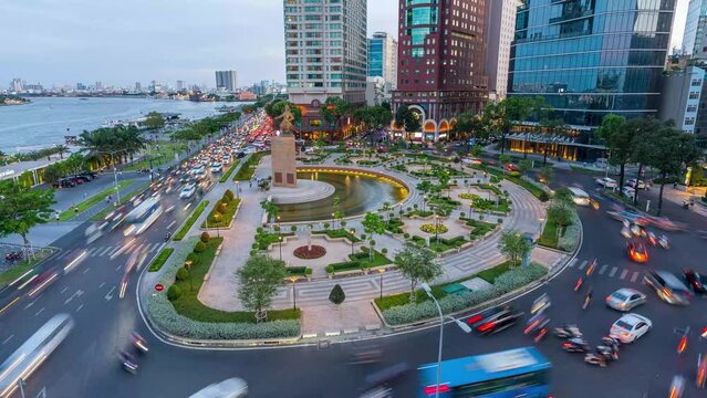 Traffic in front of Tran Hung Dao roundabout near Bach Dang port and Saigon river at twilight in Ho Chi Minh city, Vietnam. Hyper lapse.
