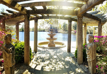 Beautiful fountain and trellis on the lake in Airlie Gardens , Wilmington , NC - 585888229