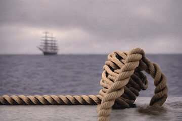 A strong knot on a pier with a 1800s sailboat in the distance, sailing at sea, cloudy day. Dreamy travel illustration. Generative AI.
