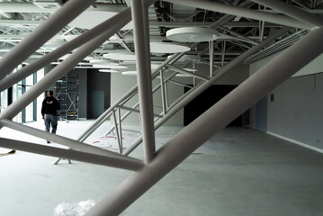 Ventilation System Under Ceiling of Modern Warehouse or Shopping Center. Metal Piping for Air Conditioning