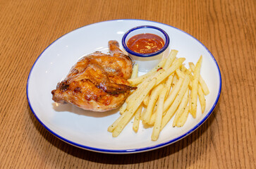 A plate with chicken and fries