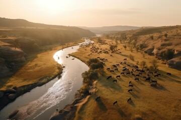 Drone view of a scenic african Landscape with mountains, a river and a herd of animals. Sunset in the distance. Generative AI