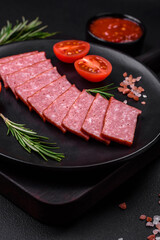 Delicious fresh sausage salami with salt, tomatoes and spices