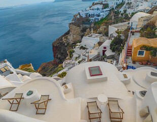 Terrace in Oia village on Santorini island, Greece. Top view of terraces on the edge of the cliff...