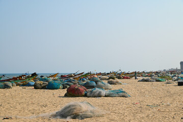 Wide beaches in the southeast of India. Chennai. Fishing boats and equipment. Fish nets.
