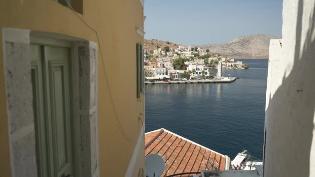 Colourful houses and clock tower in Symi Harbour from elevated position, Symi Town, Symi Island, Dodecanese Islands, Greek Islands, Greece, Europe