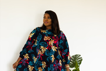 Portrait of african american woman smiling against white wall in room - inclusion and diversity...