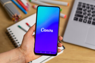 Kyiv, Ukraine - Mar. 20th, 2023: Canva logo on the screen of a mobile phone in hand.