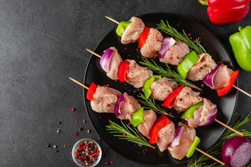 Cooking chicken kebab with vegetables. Raw chicken meat on skewers for grill or bbq. Top view....