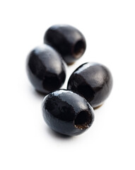Pitted black olives isolated on white background.