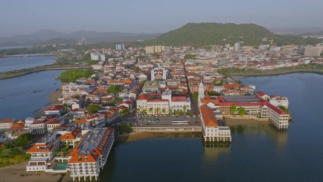 Drone morning shot of Casco Viejo old Panama City town backtracking and revealing the hole peninsula 