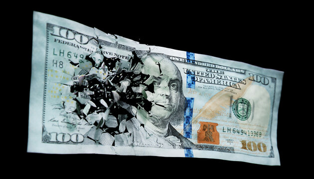 Broken US paper money on a black background
