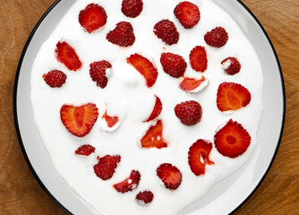 Strawberries in sour cream, ripe strawberries