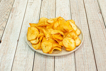 Crisp potatoes are served in the shape of a flat disk or circle, basically the shape of a potato slice lengthwise. In western countries, they are a very important part of the snack market