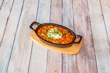 Red beans and rice is an iconic Louisiana Creole recipe traditionally made on Mondays with black beans, vegetables, spices, and leftover pork bones from Sunday dinner, all simmered together