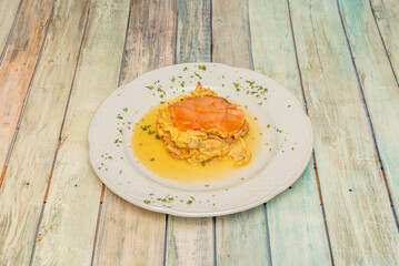 Smoked salmon is traditionally prepared in a variety of ways, often served with scrambled egg, dill, mustard, or on sandwiches