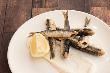 Portion of fried anchovies served as a tapa. The anchovy is highly appreciated in the cuisine of the countries of the Mediterranean basin for the flavor and soft texture of its loins.