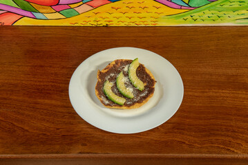 What characterizes the catrachitas is that they mix crispy fried corn tortillas with creamy fried beans and salty grated cheese