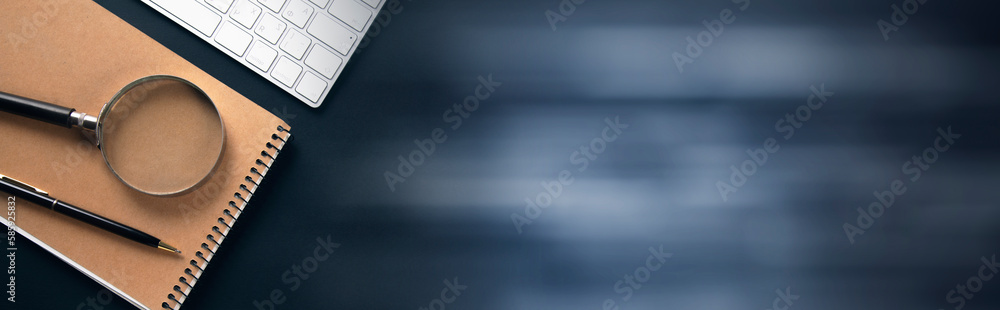 Poster computer with notepad and coffee on office table