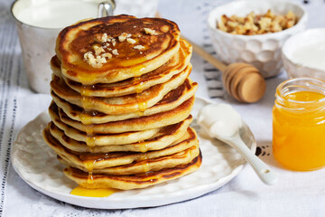 Apple pancakes served with honey, sour cream, nuts, tea and coffee.