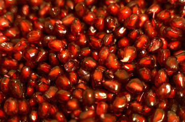 Texture of peeled red pomegranate seeds. Close-up